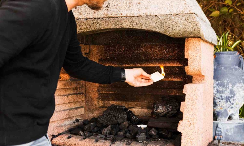 man-burning-firepit-with-paper (1)