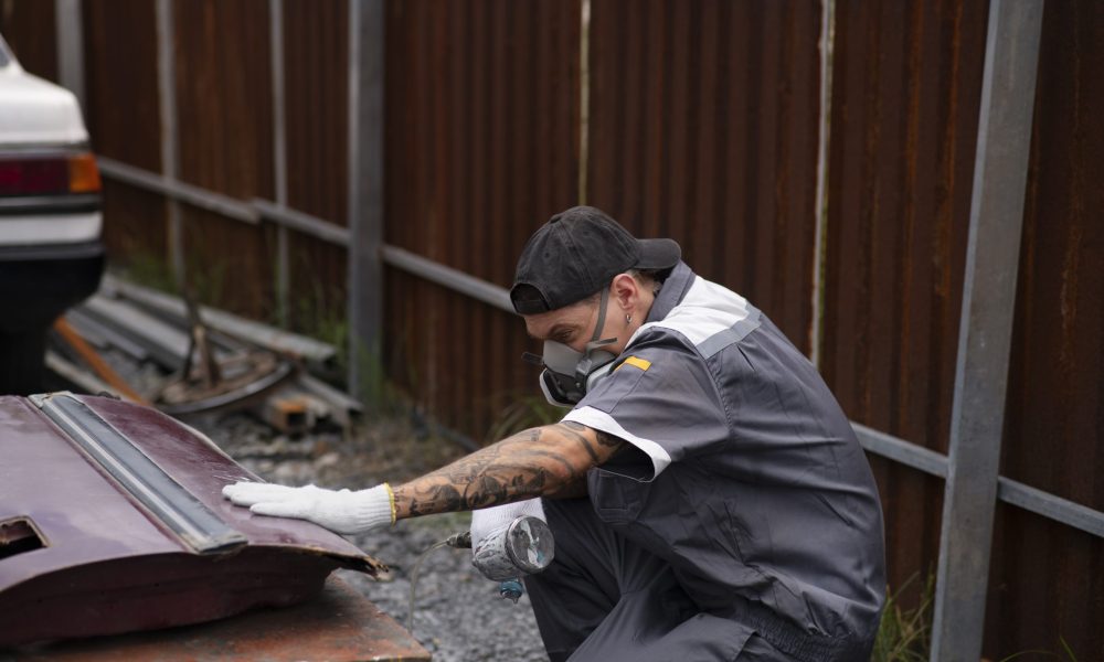 side-view-man-spraying-powder-paint