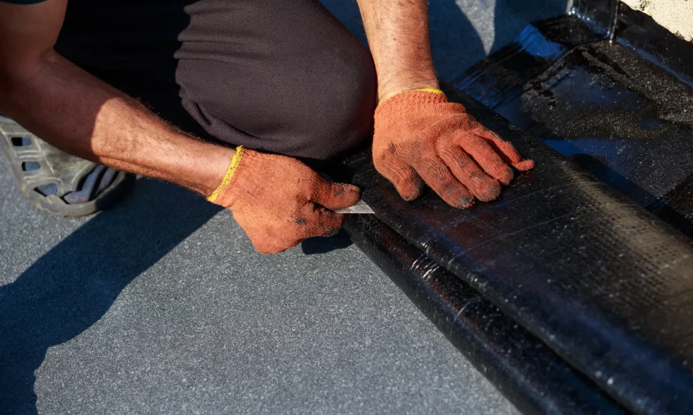 worker-cuts-roofing-material