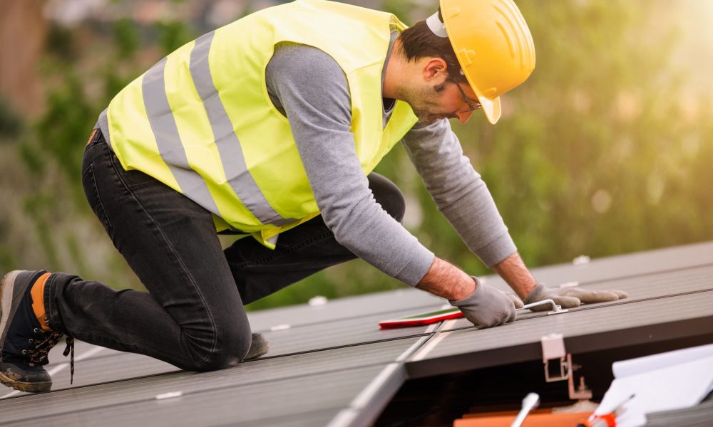 workers-assemble-energy-system-with-solar-panel-electricity-min